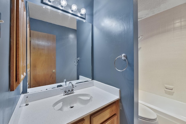 full bathroom with vanity, tiled shower / bath combo, and toilet