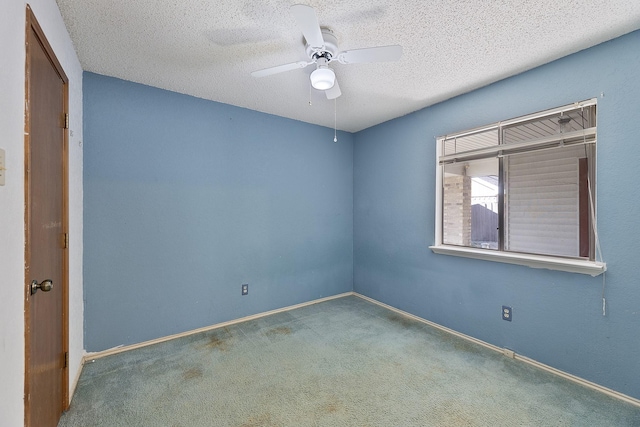 unfurnished room with ceiling fan, a textured ceiling, and carpet