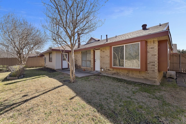 back of house with a yard and a patio area