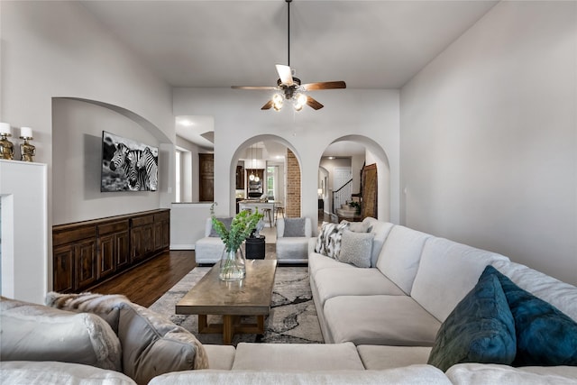 living room with dark hardwood / wood-style floors and ceiling fan