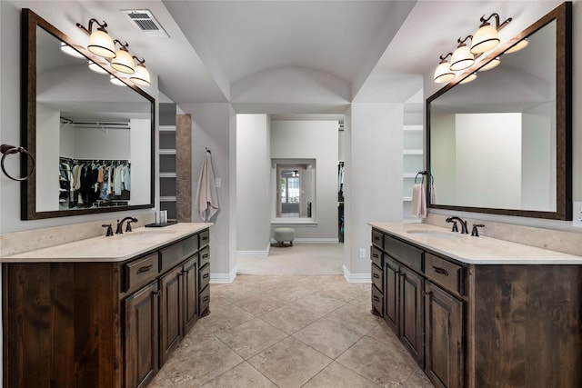 bathroom featuring tile patterned flooring and vanity