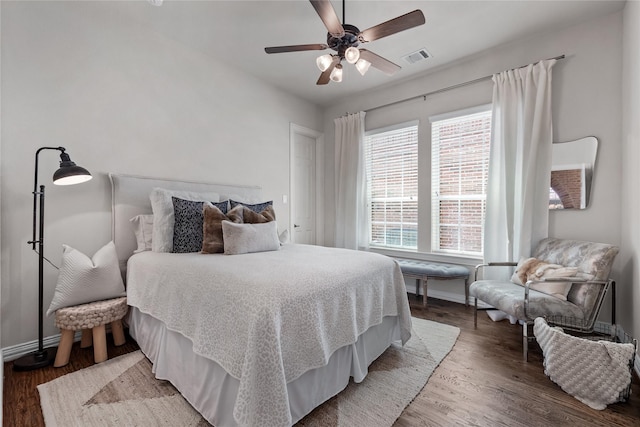 bedroom with hardwood / wood-style floors and ceiling fan