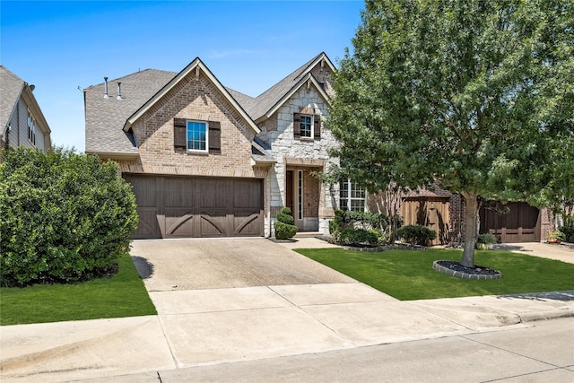 craftsman-style home featuring a garage and a front lawn