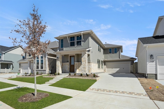 view of front of home featuring a garage, stone siding, concrete driveway, and a front yard