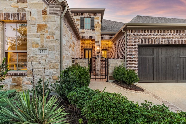 exterior entry at dusk with a garage