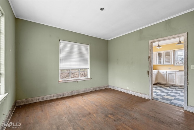 spare room featuring crown molding and hardwood / wood-style flooring