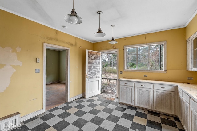 kitchen with ornamental molding, decorative light fixtures, and light brown cabinetry