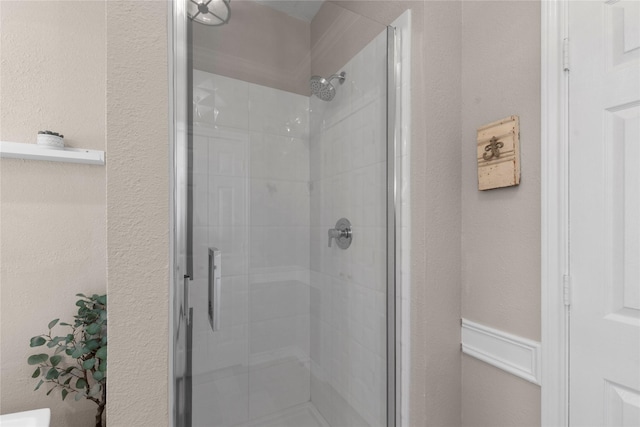 bathroom with a shower with door