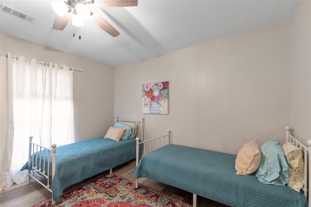 bedroom featuring hardwood / wood-style flooring and ceiling fan