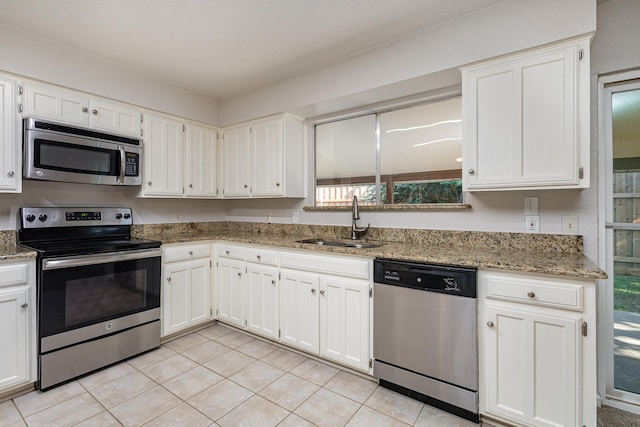 kitchen with sink, white cabinets, and appliances with stainless steel finishes