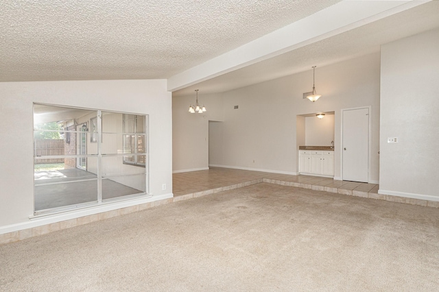 carpeted spare room with lofted ceiling, a notable chandelier, and a textured ceiling