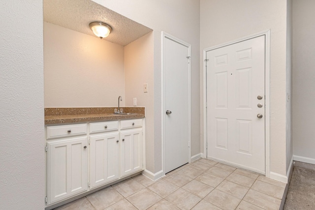 interior space featuring sink and a textured ceiling