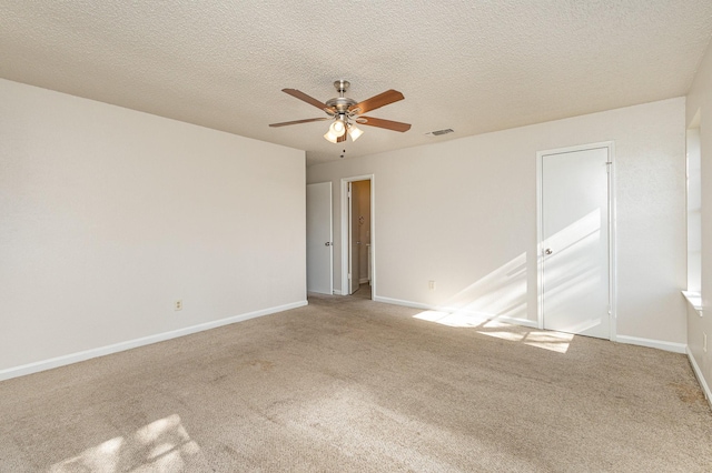 unfurnished room with ceiling fan, carpet, and a textured ceiling