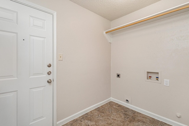 clothes washing area with washer hookup, electric dryer hookup, and a textured ceiling