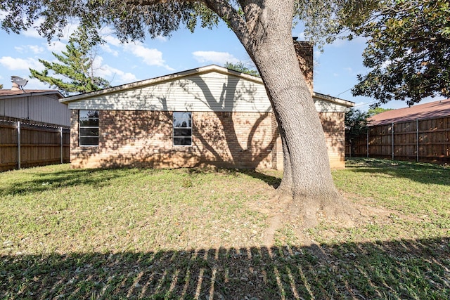 rear view of property with a yard