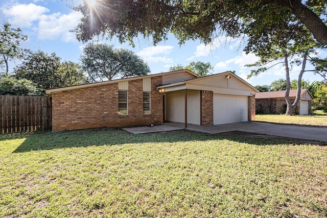 view of front of home with a garage and a front lawn