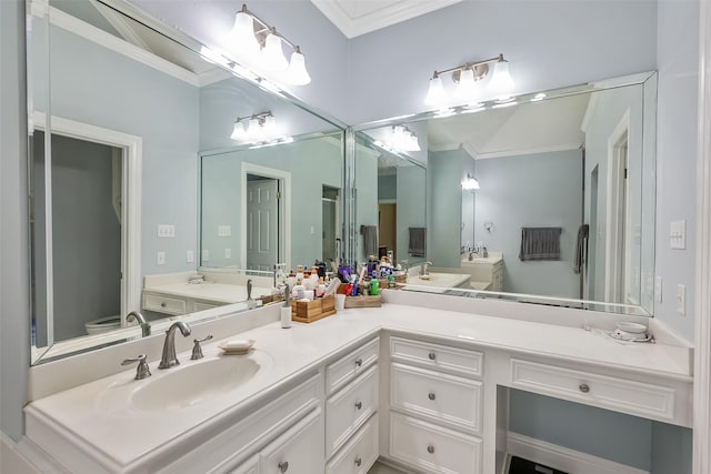 bathroom with vanity, crown molding, and toilet