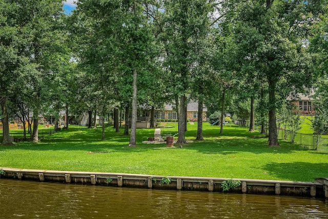 view of home's community featuring a water view and a lawn