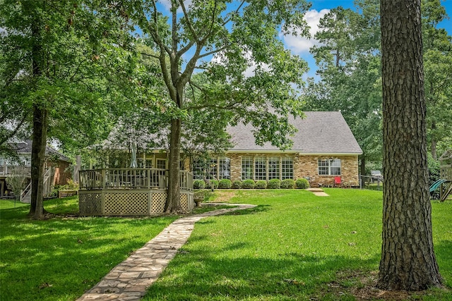 exterior space with a wooden deck and a front yard