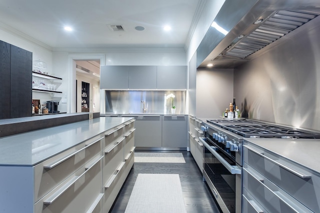 kitchen with high end stainless steel range, crown molding, dark hardwood / wood-style floors, gray cabinets, and exhaust hood