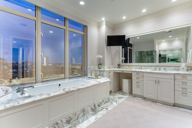 bathroom featuring ornamental molding, a bath, and vanity