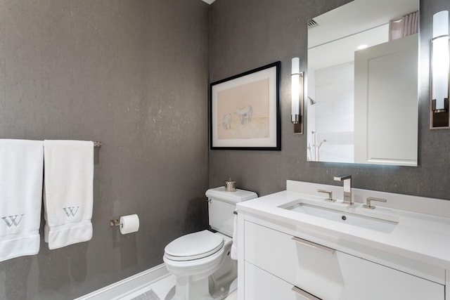 bathroom featuring vanity and toilet