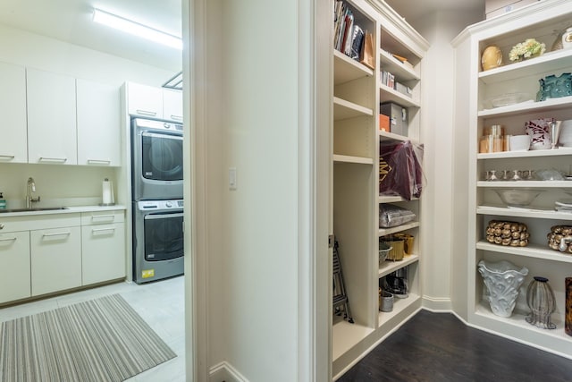 interior space with sink and stacked washing maching and dryer