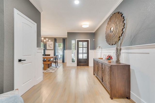 foyer entrance featuring light hardwood / wood-style flooring and ornamental molding