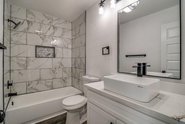 bathroom featuring shower / bath combination, toilet, and vanity