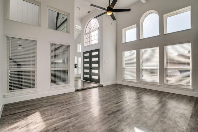 entrance foyer with dark wood-type flooring, baseboards, and a ceiling fan