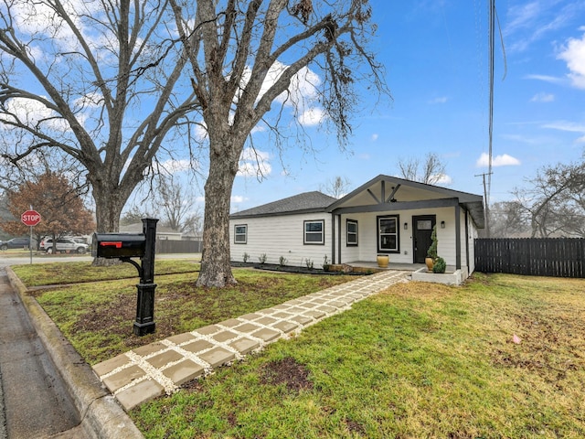 ranch-style house featuring a porch and a front yard