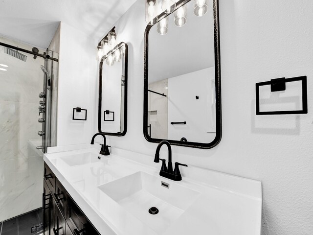 bathroom with a shower with door and vanity