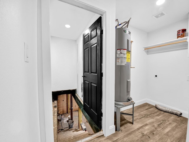 utility room featuring water heater