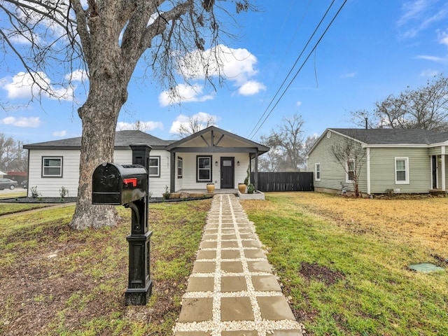 view of front of house with a front yard and covered porch