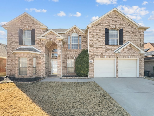 view of property with a garage and a front lawn