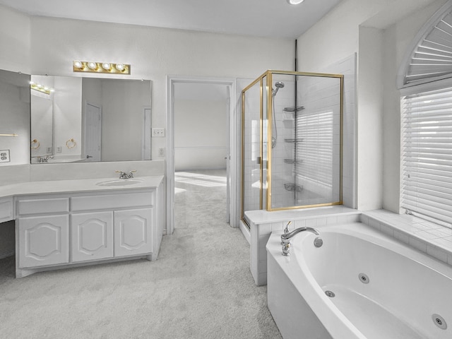 bathroom with vanity and shower with separate bathtub