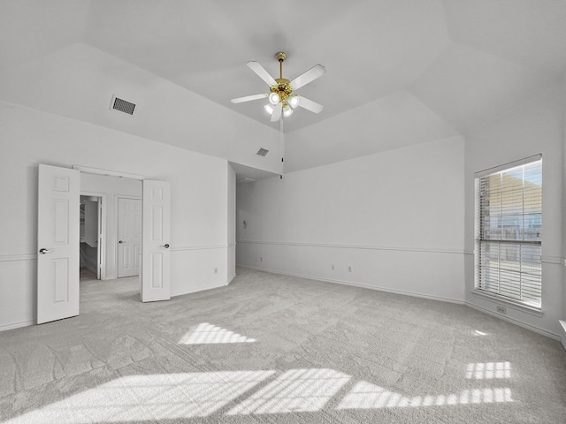 unfurnished bedroom featuring lofted ceiling, light colored carpet, and ceiling fan