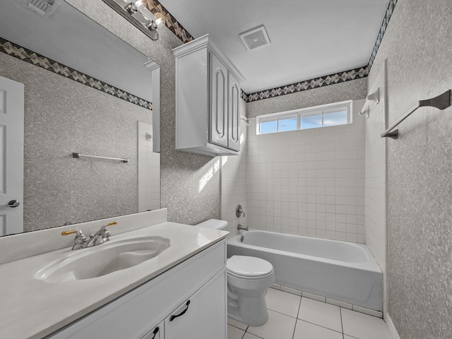 full bathroom featuring vanity, tile patterned floors, toilet, and tiled shower / bath