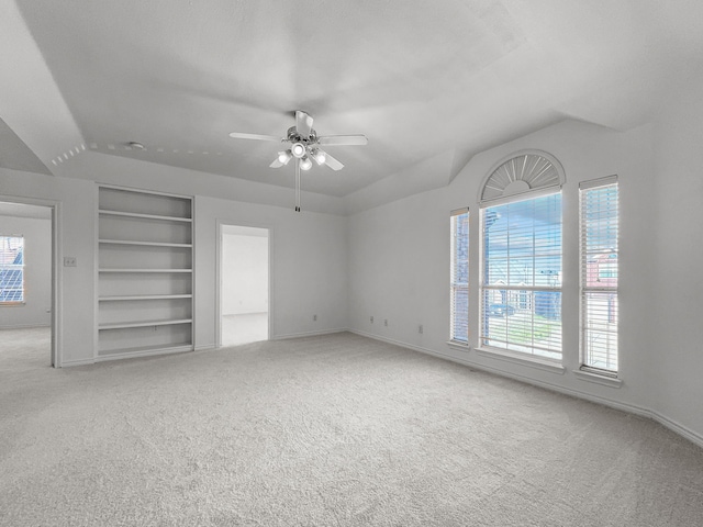 unfurnished bedroom with light carpet, multiple windows, and ceiling fan