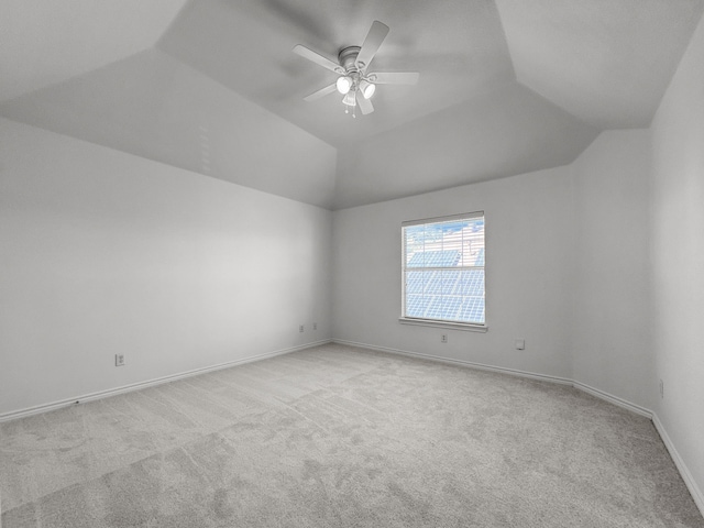 empty room with ceiling fan, lofted ceiling, and light carpet