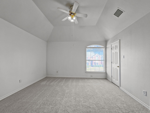 carpeted empty room with ceiling fan and vaulted ceiling