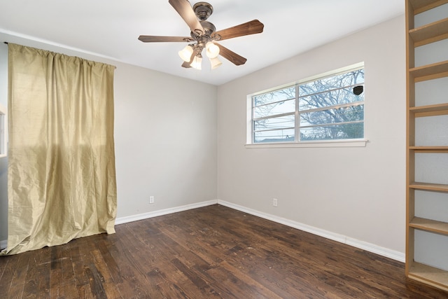 empty room featuring dark hardwood / wood-style floors and ceiling fan