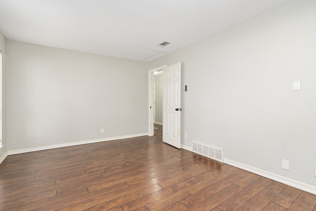 empty room featuring dark hardwood / wood-style flooring