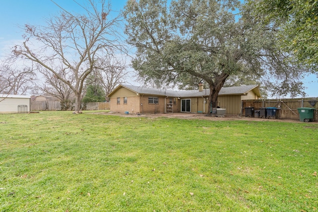 back of property with a patio and a lawn