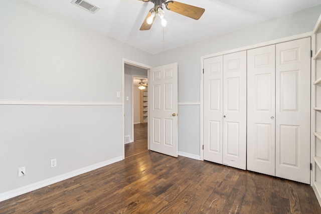 unfurnished bedroom featuring dark hardwood / wood-style floors, ceiling fan, and a closet