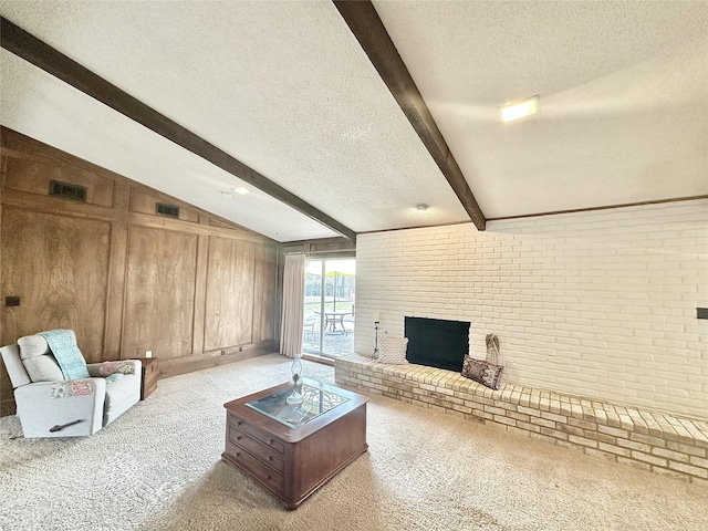 carpeted living room featuring brick wall, vaulted ceiling with beams, a textured ceiling, wood walls, and a fireplace