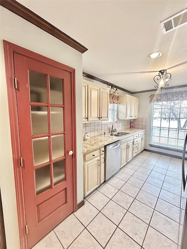 kitchen featuring cream cabinetry, stainless steel dishwasher, ornamental molding, and visible vents