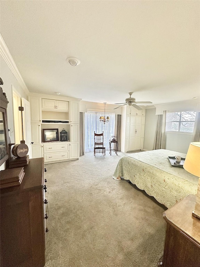 bedroom with ornamental molding, carpet, and ceiling fan with notable chandelier