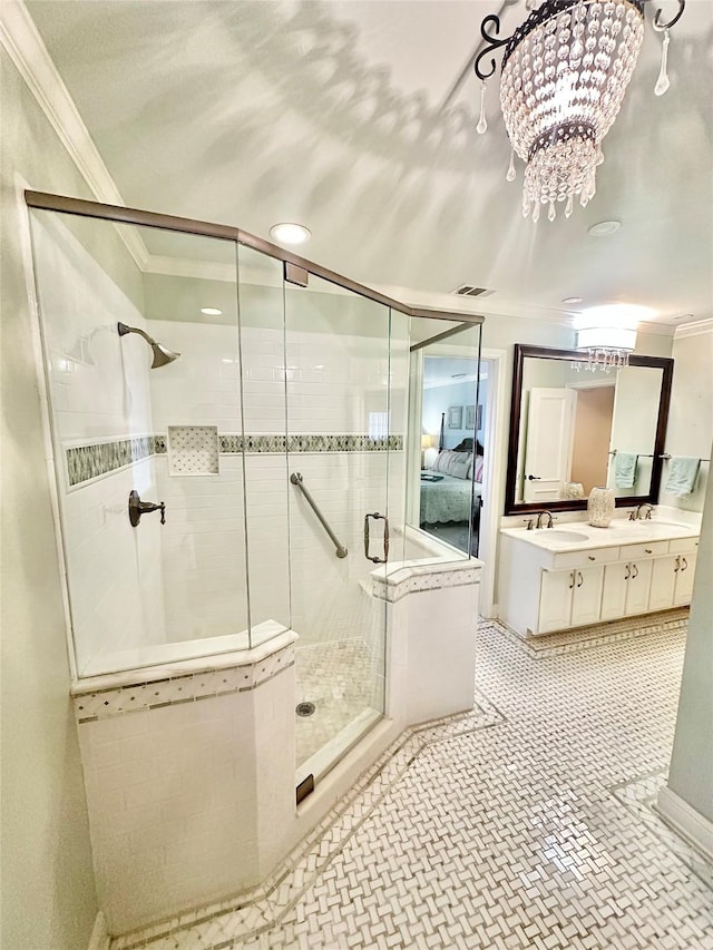 ensuite bathroom with visible vents, connected bathroom, ornamental molding, a shower stall, and a sink