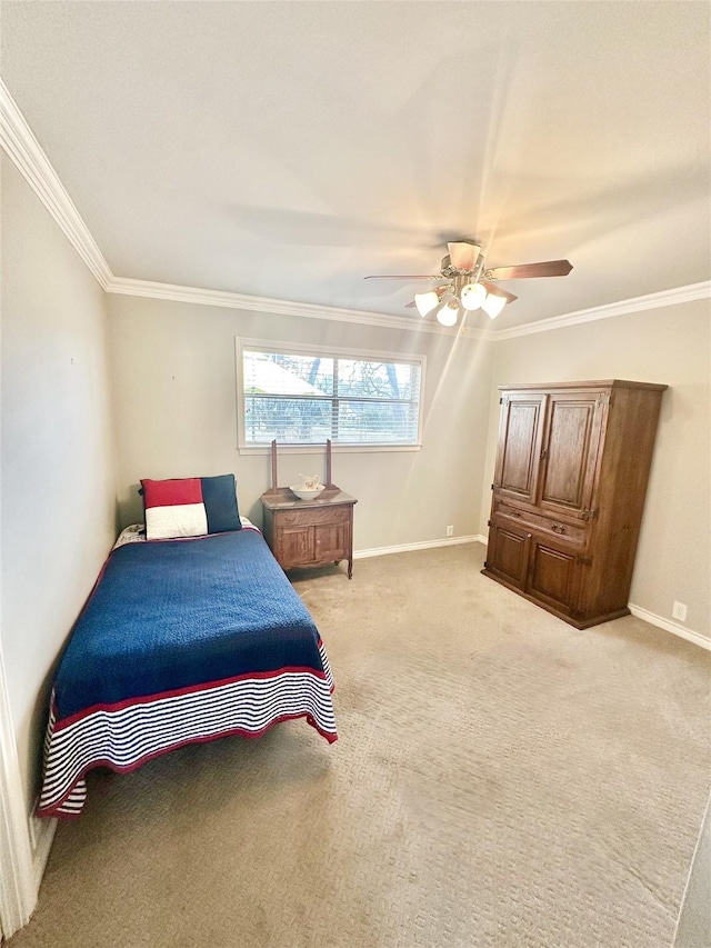 carpeted bedroom with ornamental molding, a ceiling fan, and baseboards